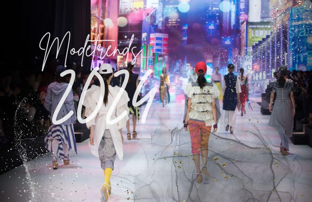 Titelbild zu einem Artikel über die Modetrends für das Jahr 2024. Mehre Models laufen über einen bunten Laufsteg.